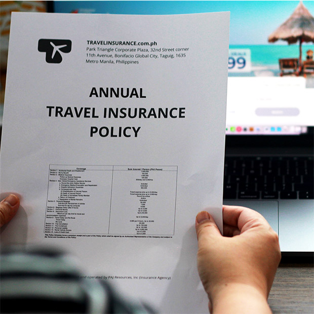 woman holding an annual travel insurance policy while booking a flight online