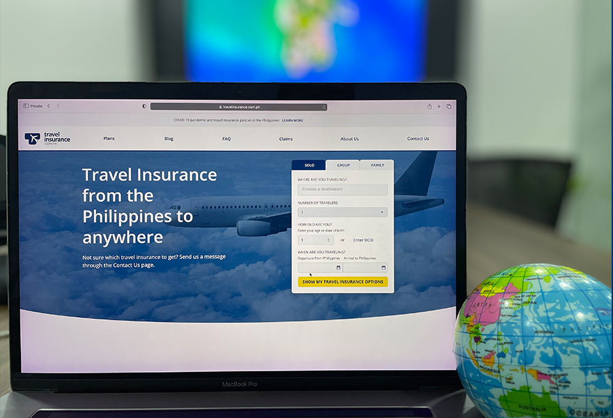 Browsing the travelinsurance.com.ph website on a laptop
