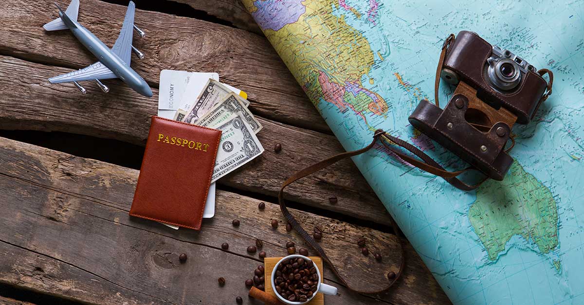 How to travel to USA. Travel requirements and documents including passport, cash, airline ticket, map, camera, with air plane miniature.